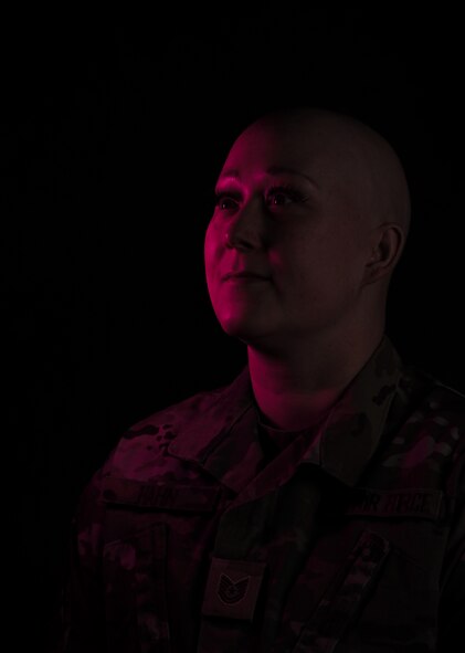 Tech. Sgt. Brandee Hahn, 5th Security Forces Squadron Combat Arms and 5 SFS Armory section chief, poses for a photo supporting breast cancer awareness at Minot Air Force Base, North Dakota, Dec. 13, 2024. In 2021, Hahn received her diagnosis; Stage 3 breast cancer at the age of 31, last April she was diagnosed with Stage 4 breast cancer and is once again in remission. Since receiving her diagnosis, she’s noticed how going through this experience has made her more understanding, more compassionate and an overall better leader, passionate about helping her Airmen and community. (U.S. Air Force photo by Airman 1st Class Alyssa Bankston)