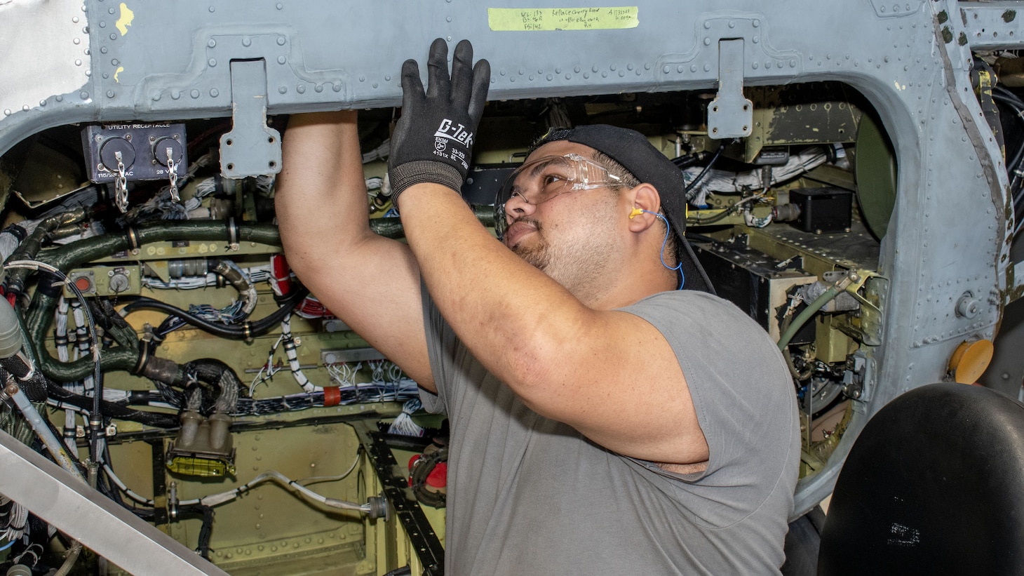 Fleet Readiness Center East (FRCE) Liam Peralta Sobrado, sheet metal helper, performs maintenance on a CH-53E Super Stallion at the depot. The Department of Defense presented FRCE with the 2024 Safety and Occupational Health Management System Achievement Award for its commitment to safety excellence, Aug. 26