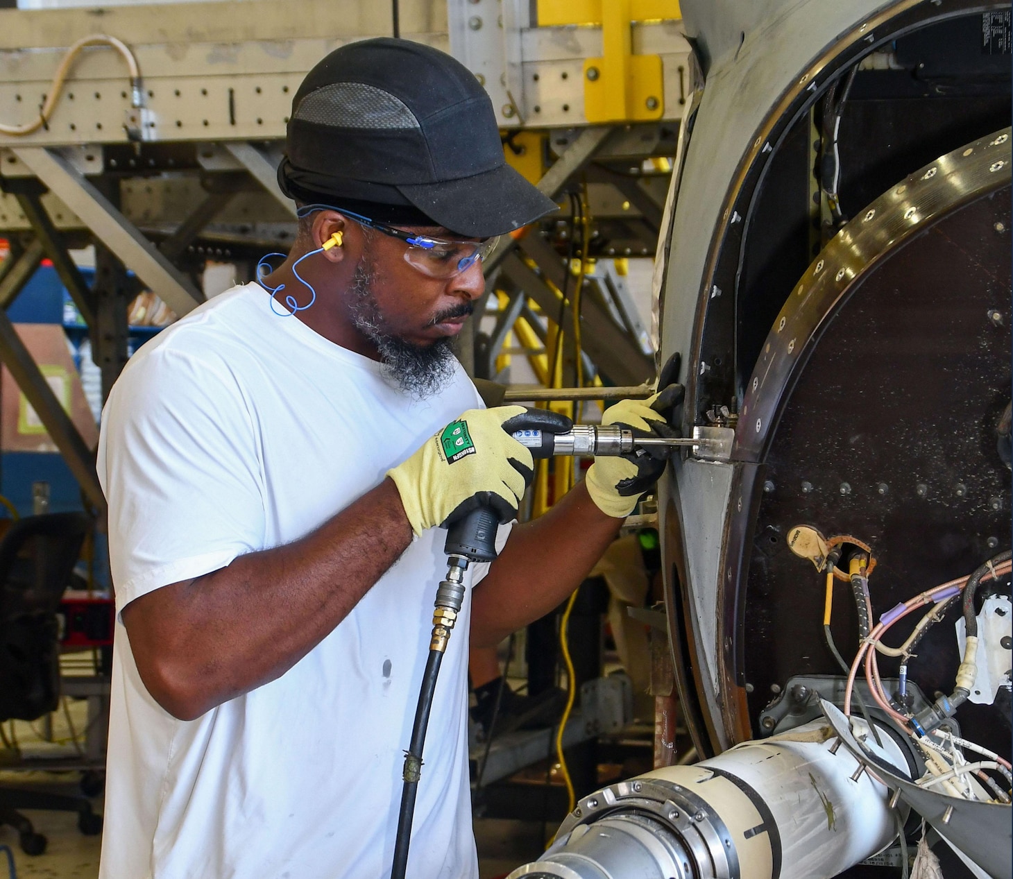 FRCE sheet metal mechanic Marshawn Becton conducts maintenance on a V-22 Osprey at the depot.