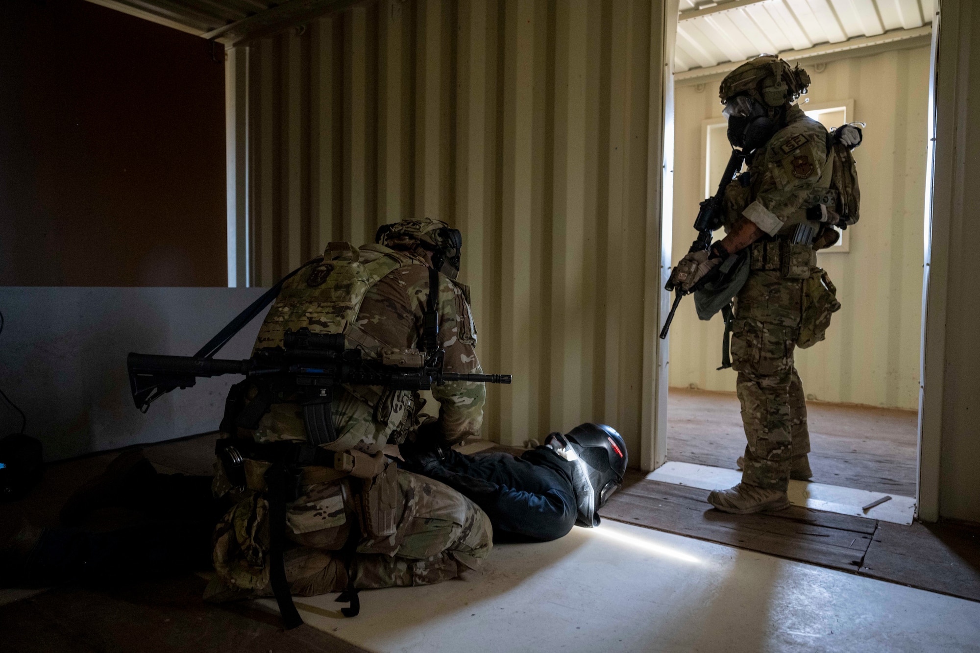 Airmen assigned to the 49th Security Forces Squadron detain a mock suspect during the "Regulator Rodeo" exercise at Holloman Air Force Base, New Mexico, Dec. 3, 2024. Defenders in the exercise demonstrated operational knowledge in air base ground defense, including small-unit tactics and close-quarters battle to create a realistic combat environment. (U.S. Air Force photo by Senior Airman Isaiah Pedrazzini)