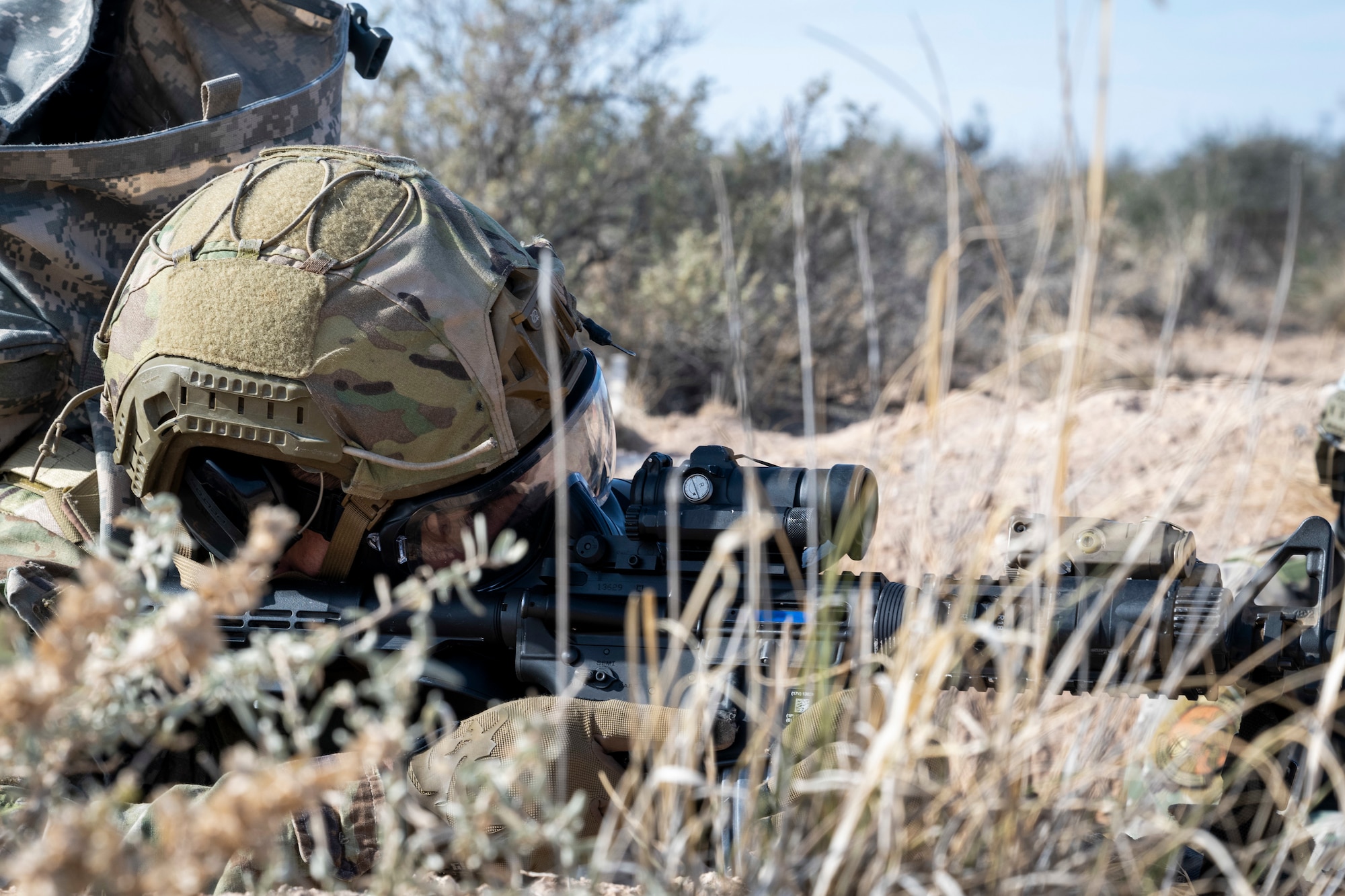 An Airman assigned to the 49th Security Forces Squadron aims down his sights during the "Regulator Rodeo" exercise at Holloman Air Force Base, New Mexico, Dec. 3, 2024. The "Regulator Rodeo" is an annual training exercise at Holloman, simulating potential missions to prepare Airmen for securing and sustaining combat operations in contested regions. (U.S. Air Force photo by Senior Airman Isaiah Pedrazzini)