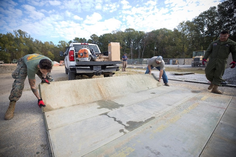 Marines from the Marine Wing Support Squadron 271, 2nd Marine Aircraft Wing assemble AM2 matting during the Airfield Matting Resurfacing experiment at the U.S. Army Engineer Research and Development Center.