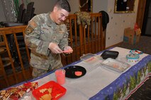 Volunteer Tech. Sgt. Nick Martinez, 75th Air Base Wing Safety Office, frosts donated cookies during the annual Team Hill Cookie Drive at Hill Air Force Base, Utah, Dec. 16, 2024. Organized volunteers representing the 388th Fighter Wing, 75th Air Base Wing, and many other units on base, along with community volunteers, came together to show support and spread holiday cheer among Airmen living in the dormitories and working in units throughout the installation. (U.S. Air Force photo by Todd Cromar)