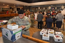 Volunteer Senior Airman Jonathan Pavon, 649th Munitions Squadron, organizes holiday cookie packages for distribution, donated by the community during the annual Team Hill Cookie Drive at Hill Air Force Base, Utah, Dec. 16, 2024. Organized volunteers representing the 388th Fighter Wing, 75th Air Base Wing, and many other units on base, along with community volunteers, came together to show support and spread holiday cheer among Airmen living in the dormitories and working in units throughout the installation. (U.S. Air Force photo by Todd Cromar)