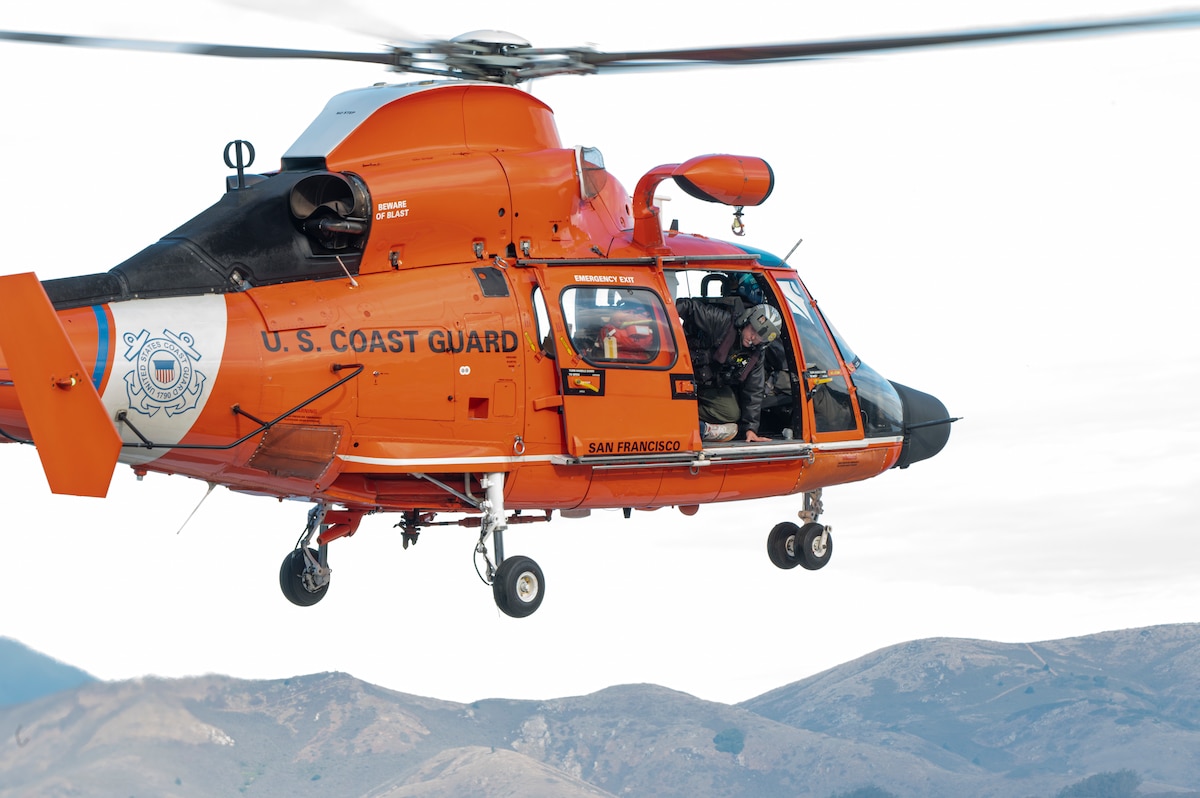 A U.S. Coast Guard guardsman performs an in-flight safety check during Exercise Sourdough in San Francisco, California, Dec. 4, 2024.