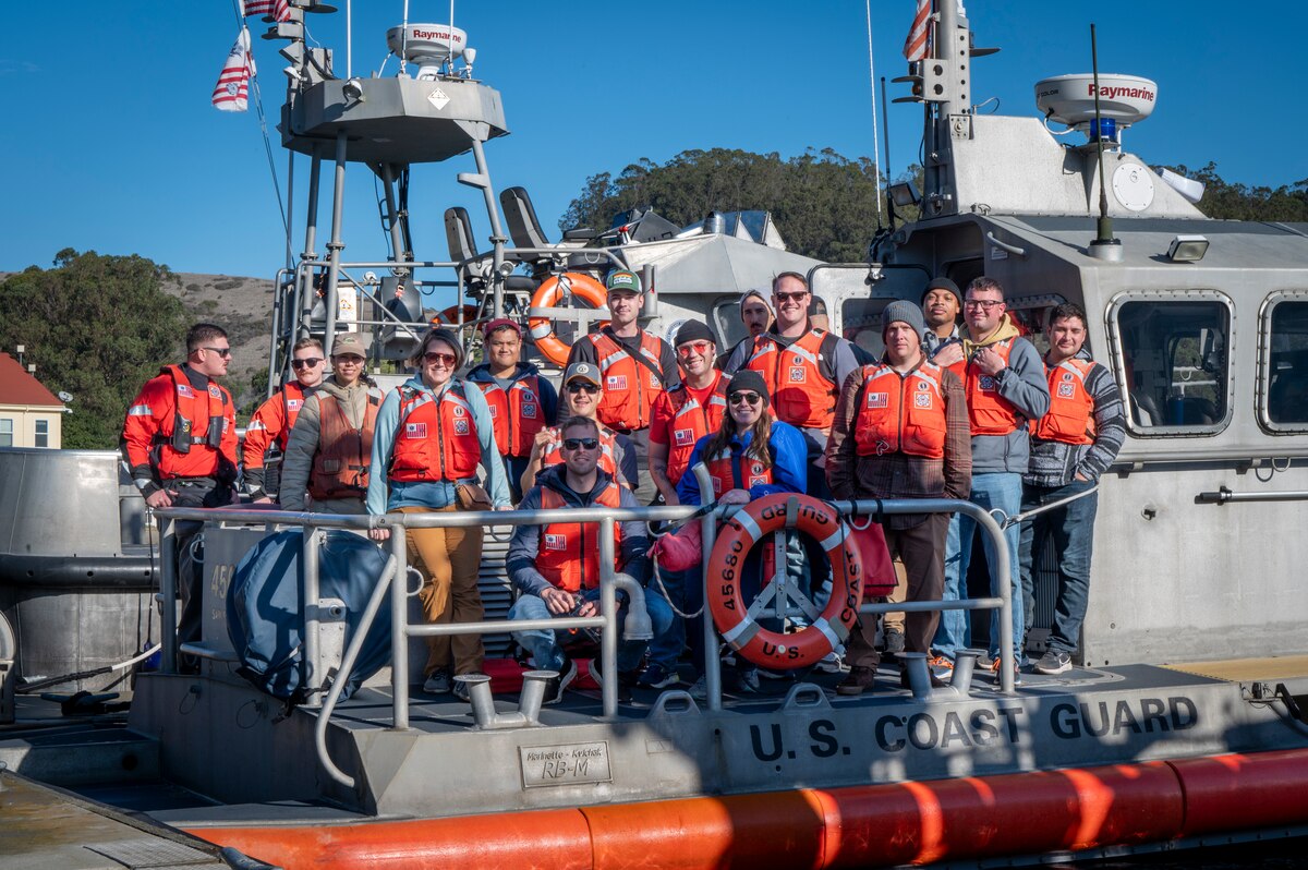 The U.S. Coast Guard and U.S. Air Force Airmen with the 571st Mobility Support Advisory Squadron pose for a photo in San Francisco, California, Dec. 5, 2024.