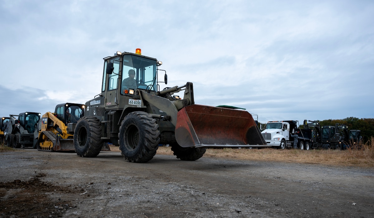 U.S. Air Force and Japan Air Self-Defense Force members line up heavy equipment.