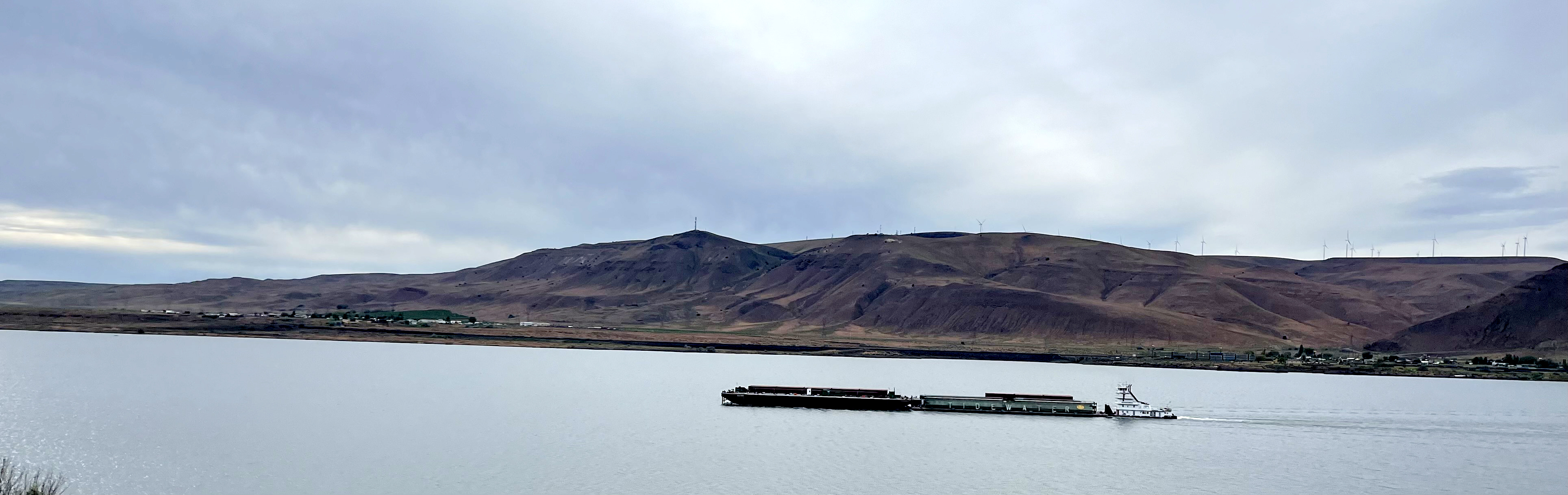 A barge transits down a river