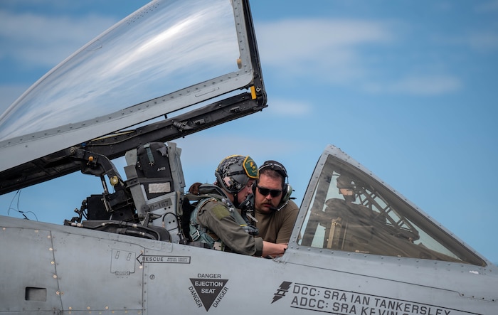 U.S. Air Force Staff Sgt. Charles Durnin, 25th Fighter Generation Squadron dedicated crew chief, communicates with Maj. Erin Crow, 25th Fighter Squadron A-10 pilot, before a flight at Clark Air Base, Philippines, Dec. 14, 2024. The U.S. and Philippine Air Forces are participating in a Dynamic Force Employment exercise, enabling combined and joint force commanders to rapidly deploy forces across the region and to maintain operational readiness, resilience, and operational initiative. (U.S. Air Force photo by Staff Sgt. Christopher Tam)