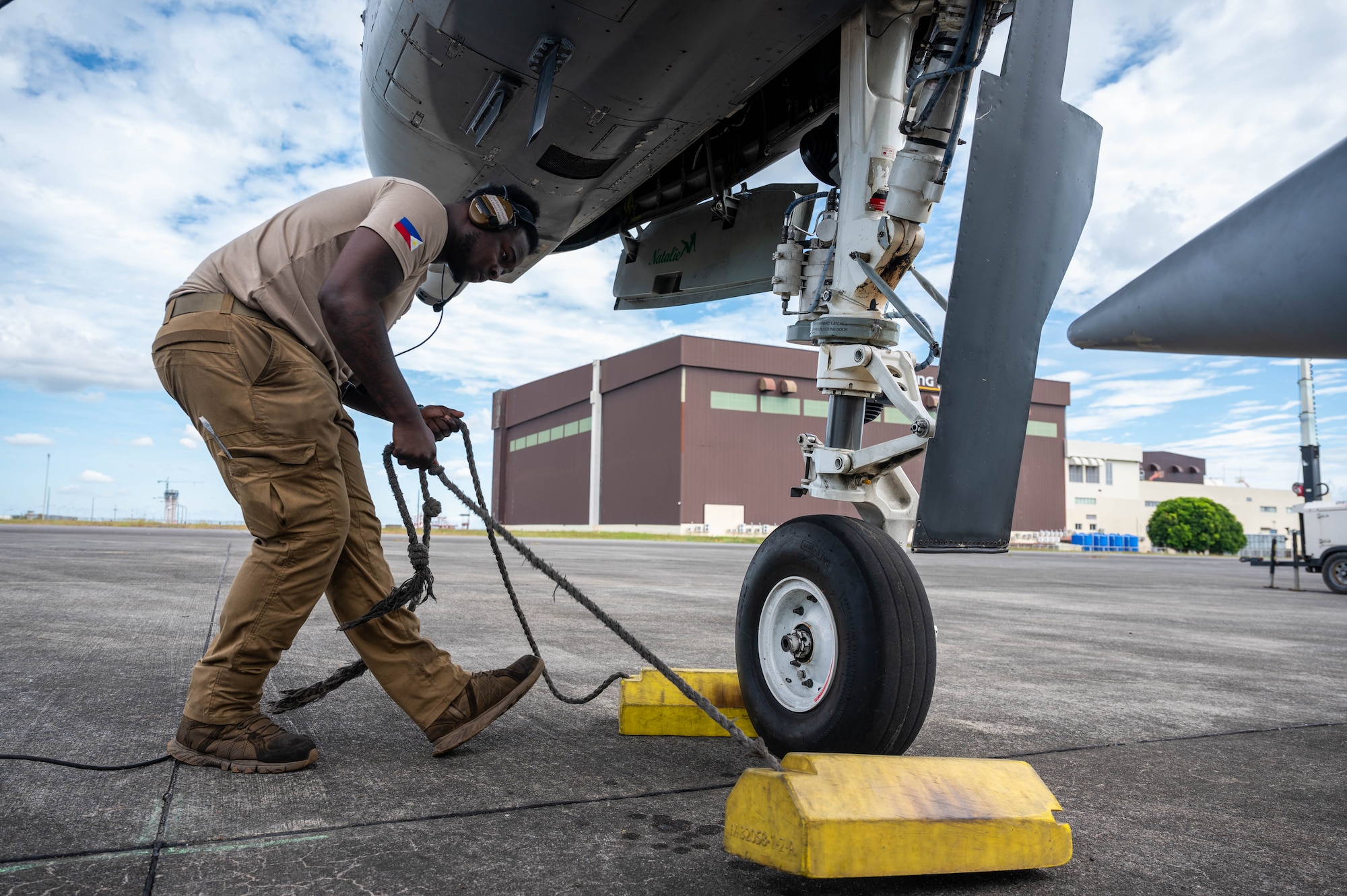 U.S. Air Force Senior Airman Ke’von Heath, 25th Fighter Generation Squadron dedicated crew chief, removes chalks before a flight at Clark Air Base, Philippines, Dec. 14, 2024. The A-10s are participating in bilateral training with the Philippine Air Force as part of a Dynamic Force Employment exercise, strengthening trust, enhancing regional security, and promoting shared values under international law. (U.S. Air Force photo by Staff Sgt. Christopher Tam)