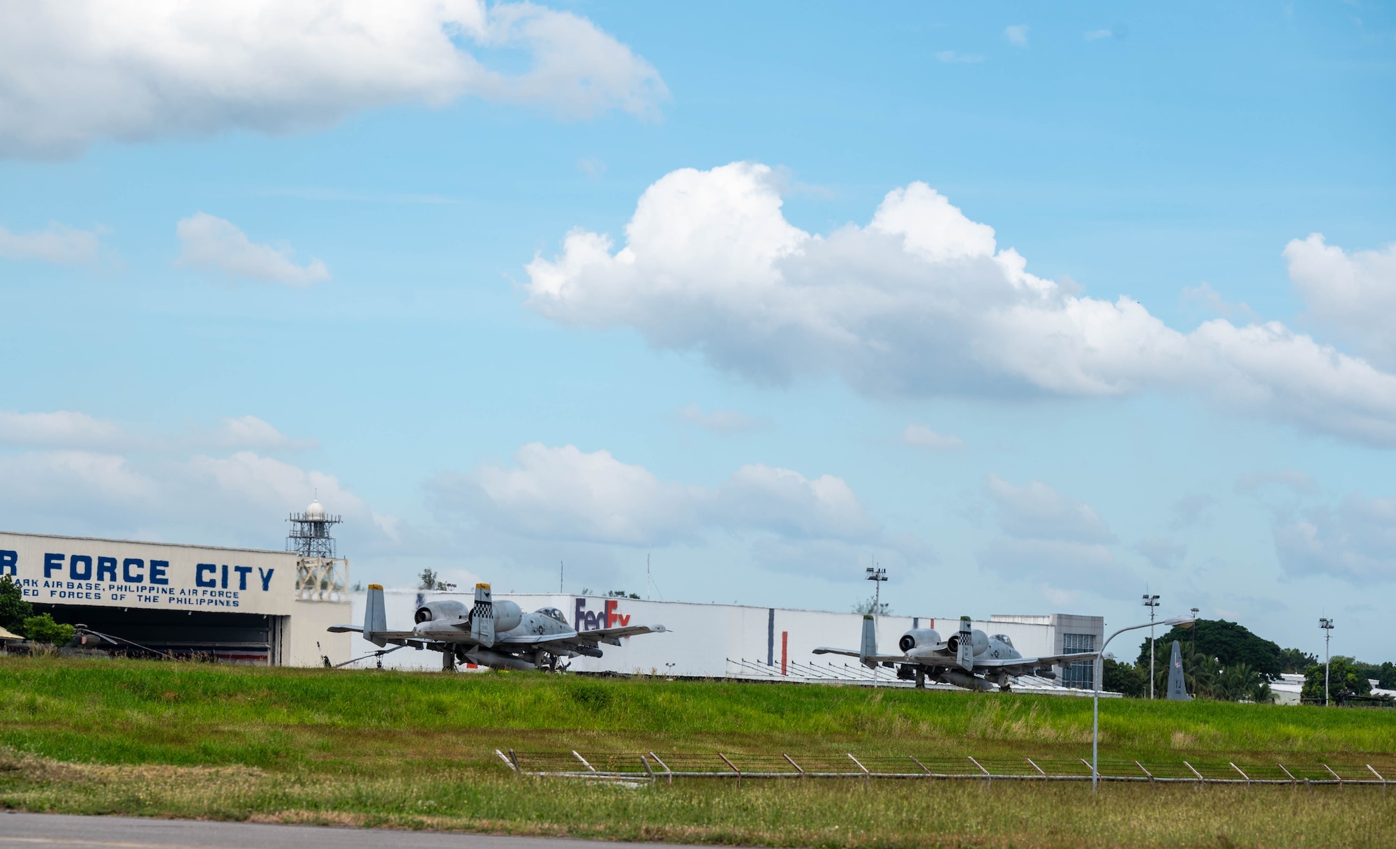 Two U.S. Air Force A-10 Thunderbolt IIs assigned to the 25th Fighter Squadron taxi before a flight back to Osan Air Base from Clark Air Base, Philippines, Dec. 14, 2024. The A-10s participated in bilateral training with the Philippine Air Force as part of a Dynamic Force Employment exercise, strengthening trust, enhancing regional security, and promoting shared values under international law. (U.S. Air Force photo by Staff Sgt. Christopher Tam)
