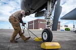 U.S. Air Force Senior Airman Ke’von Heath, 25th Fighter Generation Squadron dedicated crew chief, removes chalks before a flight at Clark Air Base, Philippines, Dec. 14, 2024. The A-10s are participating in bilateral training with the Philippine Air Force as part of a Dynamic Force Employment exercise, strengthening trust, enhancing regional security, and promoting shared values under international law. (U.S. Air Force photo by Staff Sgt. Christopher Tam)