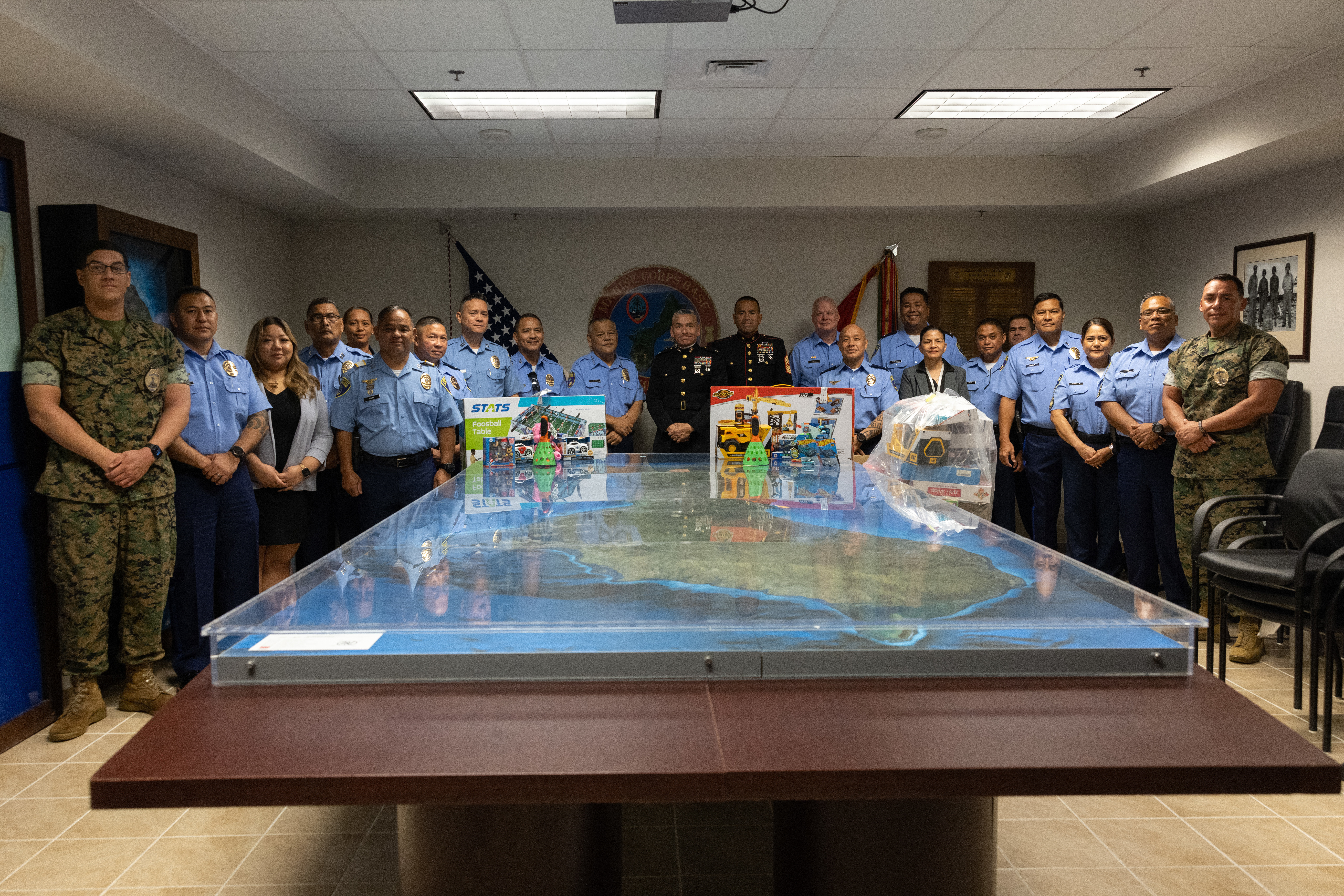Members of the Guam Police Department pose with U.S. Marines at Marine Corps Base Camp Blaz, Guam, Dec. 13, 2024. Guam PD visited MCB Camp Blaz to drop off more than 100 toys for the 2024 Toys for Tots campaign. The Marine Corps Toys for Tots program collects new, unwrapped toys for distribution to children in the local area and neighboring Commonwealth of the Mariana Islands during the holiday season. (U.S. Marine Corps photo by Lance Cpl. Rey Moreno Marilao)