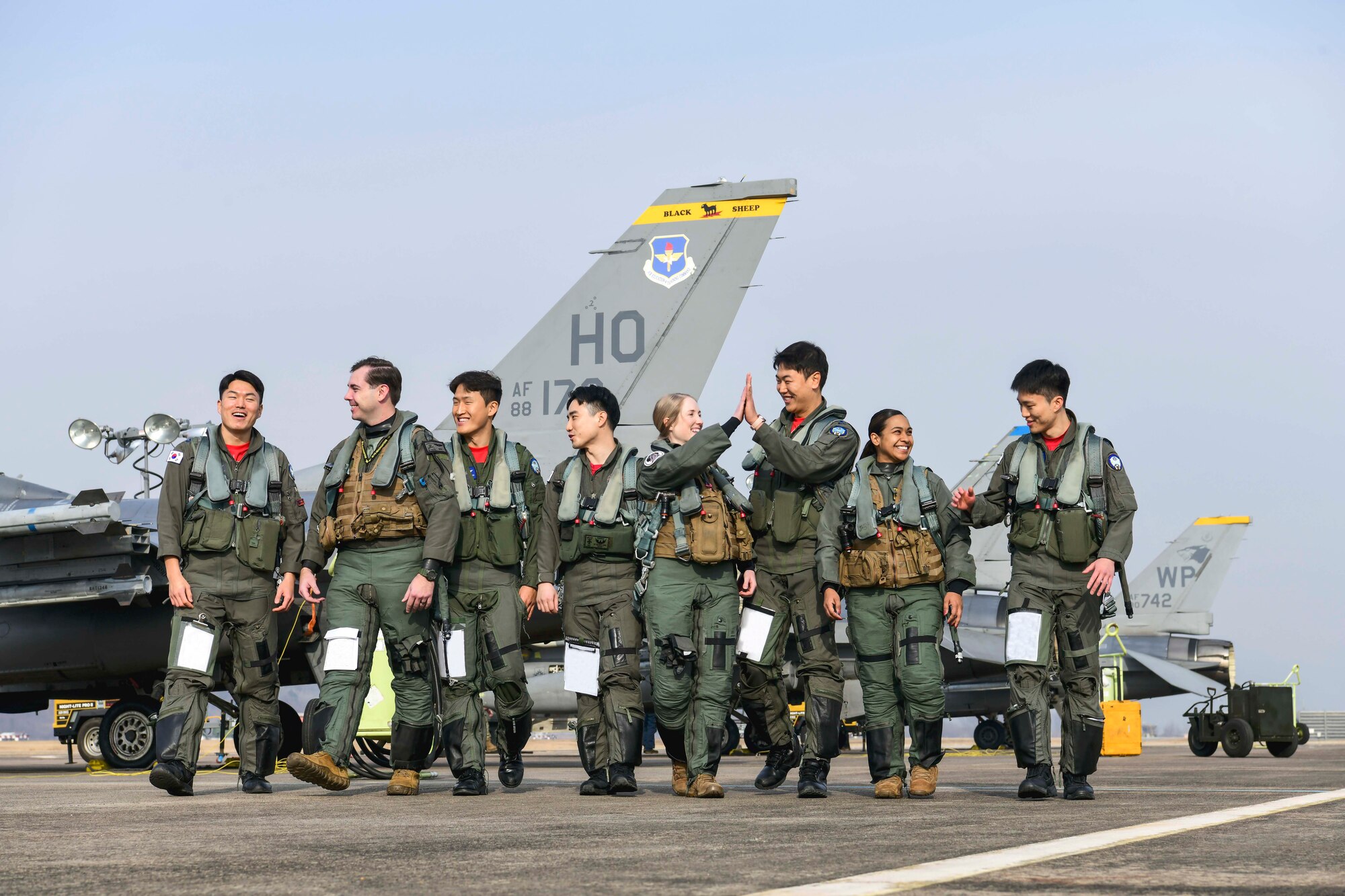 U.S. Air Force and Republic of Korea Air Force Airmen walk on the flightline together