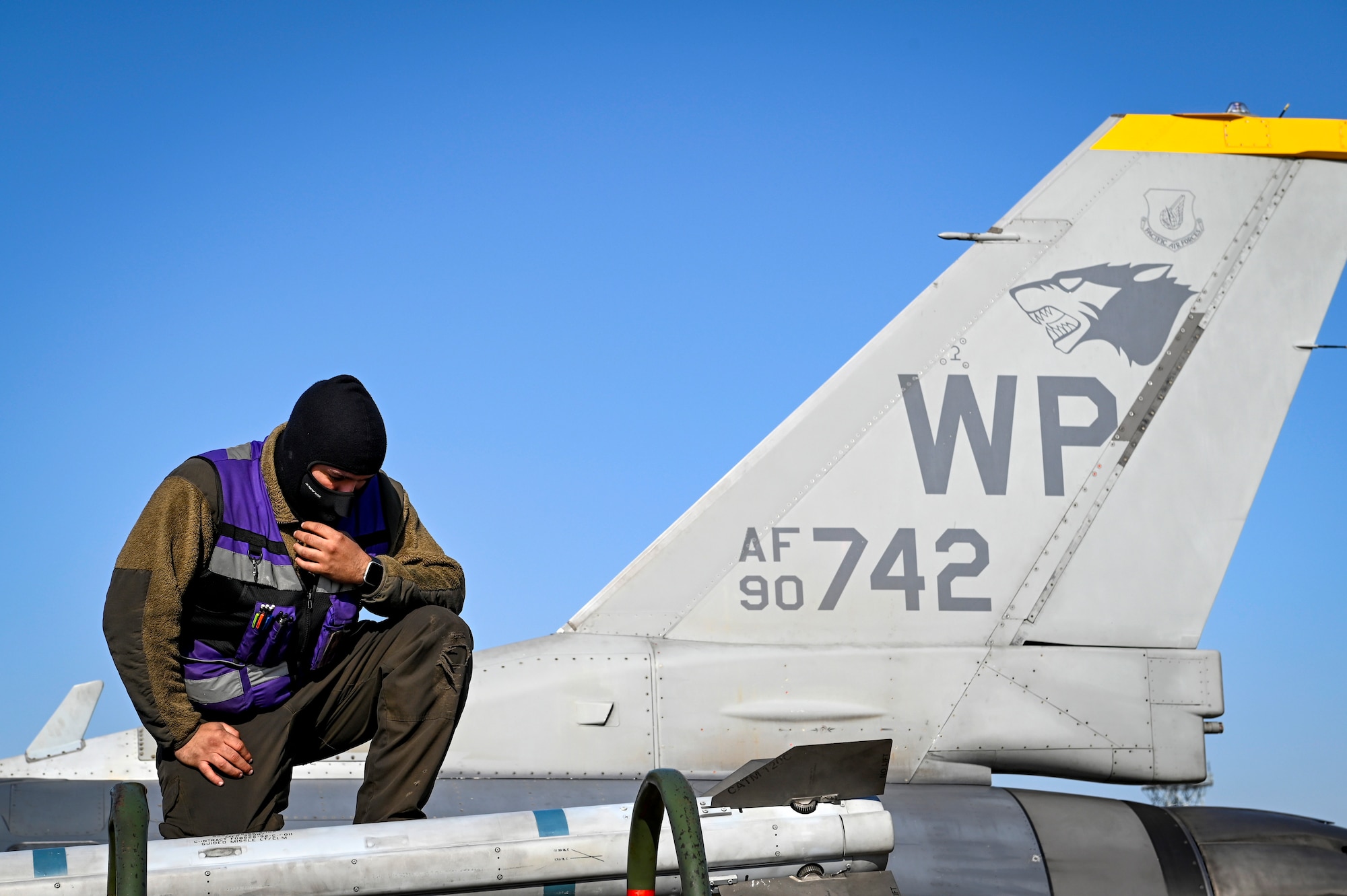 A person inspects a training missile