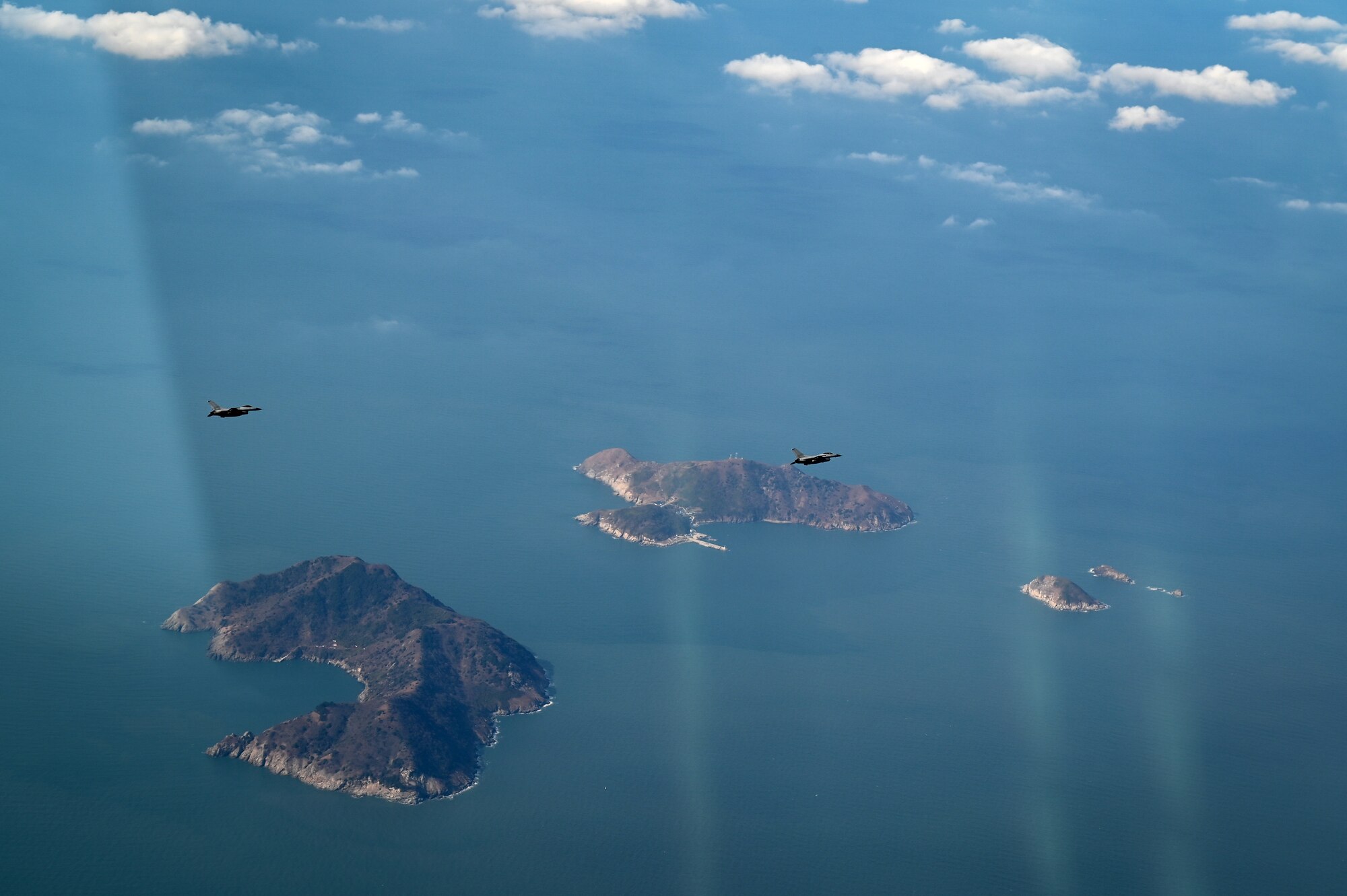 F-16s fly over water