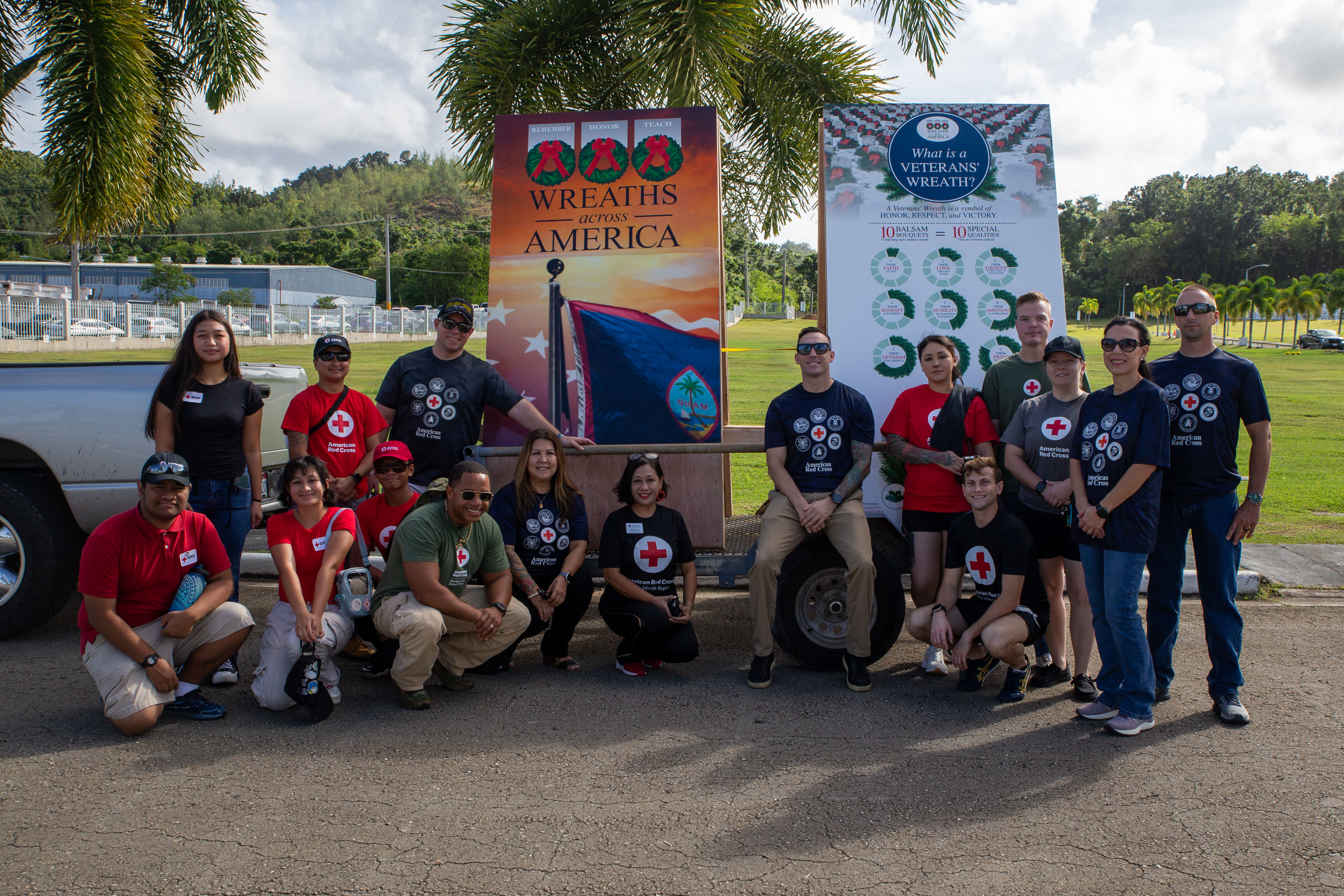 U.S. service members and Red Cross Volunteers pose for a photo before the 4th annual Wreaths Across America Ceremony at the Guam Veterans Cemetery, Piti, Guam, Dec. 14, 2024. The wreaths were placed for Wreaths Across America Day, in which thousands of wreaths are placed on graves in military cemeteries across the United States. (U.S. Marine Corps photo by Lance Cpl. Afton Smiley)