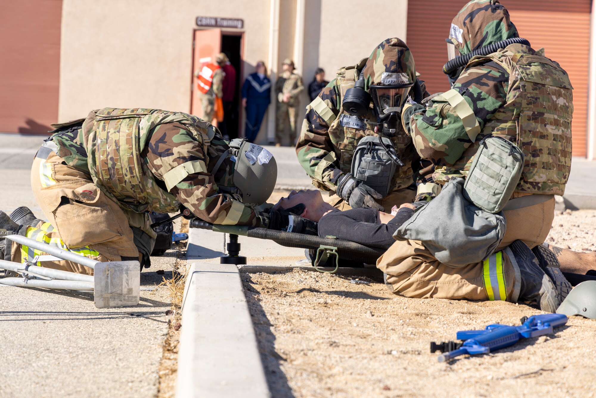 412th Test Wing Airmen respond to simulated medical casualty during a Combat Readiness Exercise on Edwards Air Force Base, California, Dec. 6. (Air Force photo by Daniel Kelley)