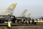 Cobra members service an F-16 Fighting Falcon aircraft during Buddy Squadron 25-3, at Jungwon Air Base, ROK, Dec. 11, 2024. The five-day training event was meant to increase interoperability while employing airpower jointly with ROKAF mission partners. (U.S. Air Force photo by Tech. Sgt. Stephanie Serrano)