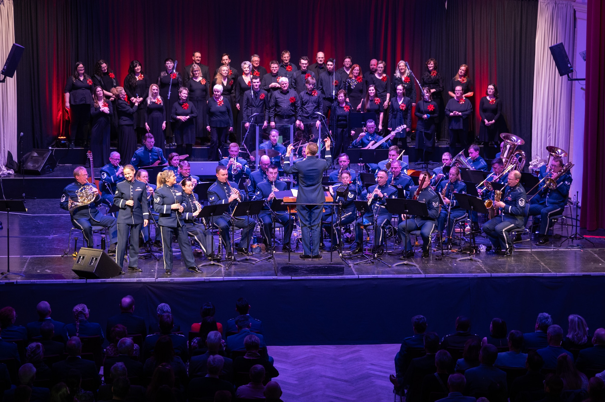 The U.S. Air Forces in Europe - Air Forces Africa and the Rheinland-Pfalz International Choir perform for an audience of military members and German nationals during the Kaiserslautern Military Community Christmas concert at the Fruchthalle in Kaiserslautern, Germany, Dec. 13, 2024. The USAFE-AFAFRICA band consistently performs within the local community to bolster a unique and powerful partnership that has been vital to mission success for several decades. (U.S. Air Force photo by Senior Airman Renan Arredondo)