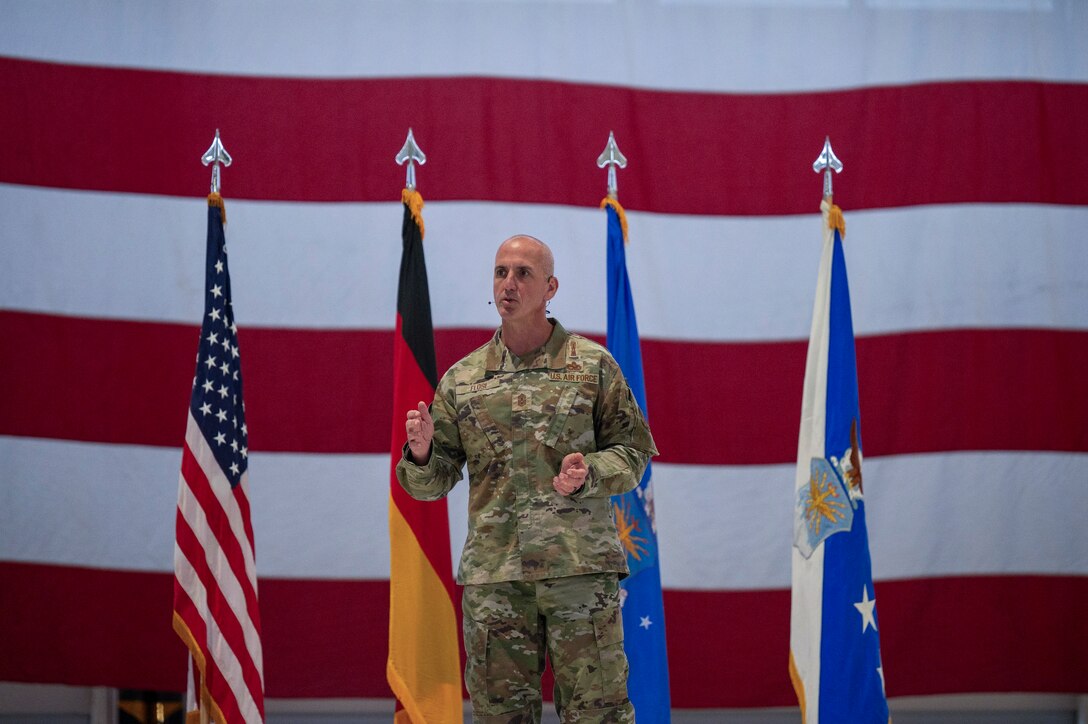 Military leadership briefs a crowd.