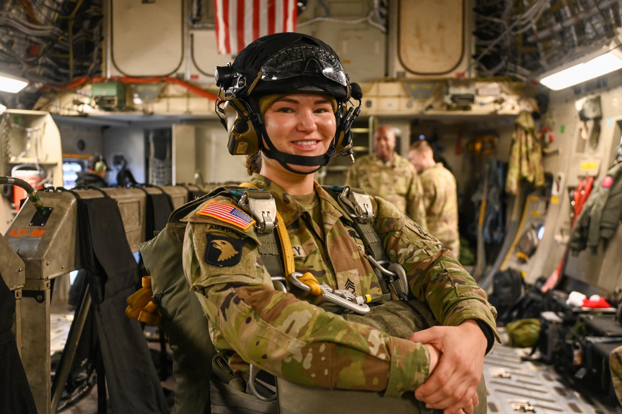 U.S. Army Reserve Staff Sgt. Tana Aley, United States Army Civil Affairs and Psychological Operations Command (Airborne), air division noncommissioned officer, stands ready during an airlift to the Sicily Drop Zone at Fort Liberty, North Carolina, Dec. 9, 2024. This year, more than 3,000 jumpers participated in Operation Toy Drop. (U.S. Air Force photo by Senior Airman Kari Degraffenreed)