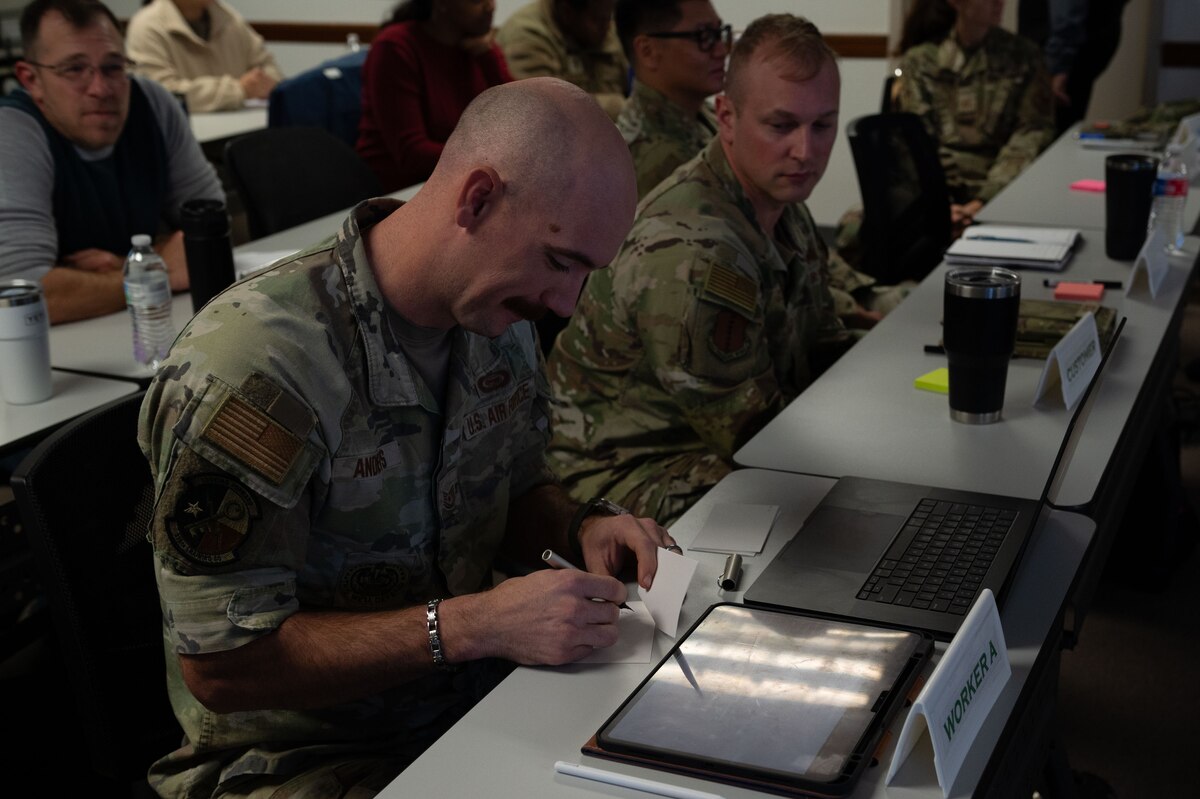 Students assigned to different teams create a ‘product’ during a simulation in the Practical Problem-Solving Methodology class at the Military Family Readiness Center, Goodfellow Air Force Base, Texas, Dec. 11, 2024. The simulation demonstrated the chaotic nature of working together without an established process to identify and solve problems. (U.S. Air Force photo by Airman 1st Class Brian Lummus)