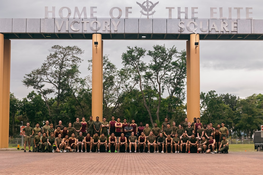 U.S. Marines and Sailors with Marine Rotational Force-Southeast Asia, I Marine Expeditionary Force, alongside Singapore Guardsmen with 3rd Battalion Singapore Guards, 7th Singapore Infantry Brigade, pose for a photo after a physical training session prior to the commencement of Valiant Mark 24 on Bedok Camp, Singapore, Dec. 9, 2024. Valiant Mark is an annual, bilateral training exercise conducted between the Singapore Armed Forces and I MEF, designed to enhance interoperability, improve combined arms and amphibious warfighting skills, and strengthen military-to-military relationships. MRF-SEA is a rotational unit derived from elements of I MEF executing a U.S. Marine Corps Forces, Pacific operational model that involves training events and exchanges with partner military subject matter experts, promotes security goals with Allied and partner nations, and ensures a persistent I MEF stand-in presence west of the International Date Line. (U.S. Marine Corps photo by Sgt. Shaina Jupiter)