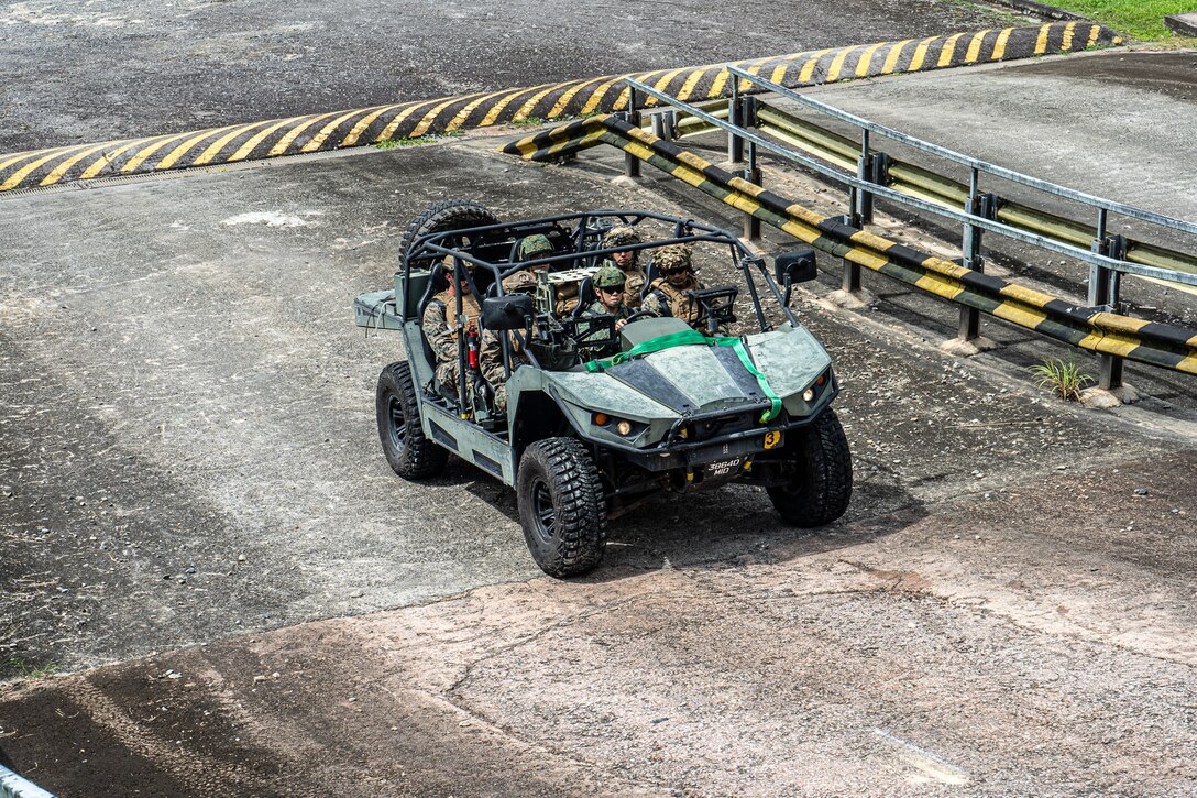 U.S. Marines with 2nd Battalion, 7th Marine Regiment, attached to Marine Rotational Force-Southeast Asia, alongside Singapore Guardsmen with 7th Singapore Infantry Brigade, conduct an anti-tank subject matter expert exchange during Valiant Mark 24 on Pasir Laba Camp, Singapore, Dec. 10, 2024. Valiant Mark is an annual, bilateral training exercise conducted between the Singapore Armed Forces and I MEF, designed to enhance interoperability, improve combined arms and amphibious warfighting skills, and strengthen military-to-military relationships. MRF-SEA is a rotational unit derived from elements of I MEF executing a U.S. Marine Corps Forces, Pacific operational model that involves training events and exchanges with partner military subject matter experts, promotes security goals with Allied and partner nations, and ensures a persistent I MEF stand-in presence west of the International Date Line. (Courtesy asset of the Singapore Armed Forces)