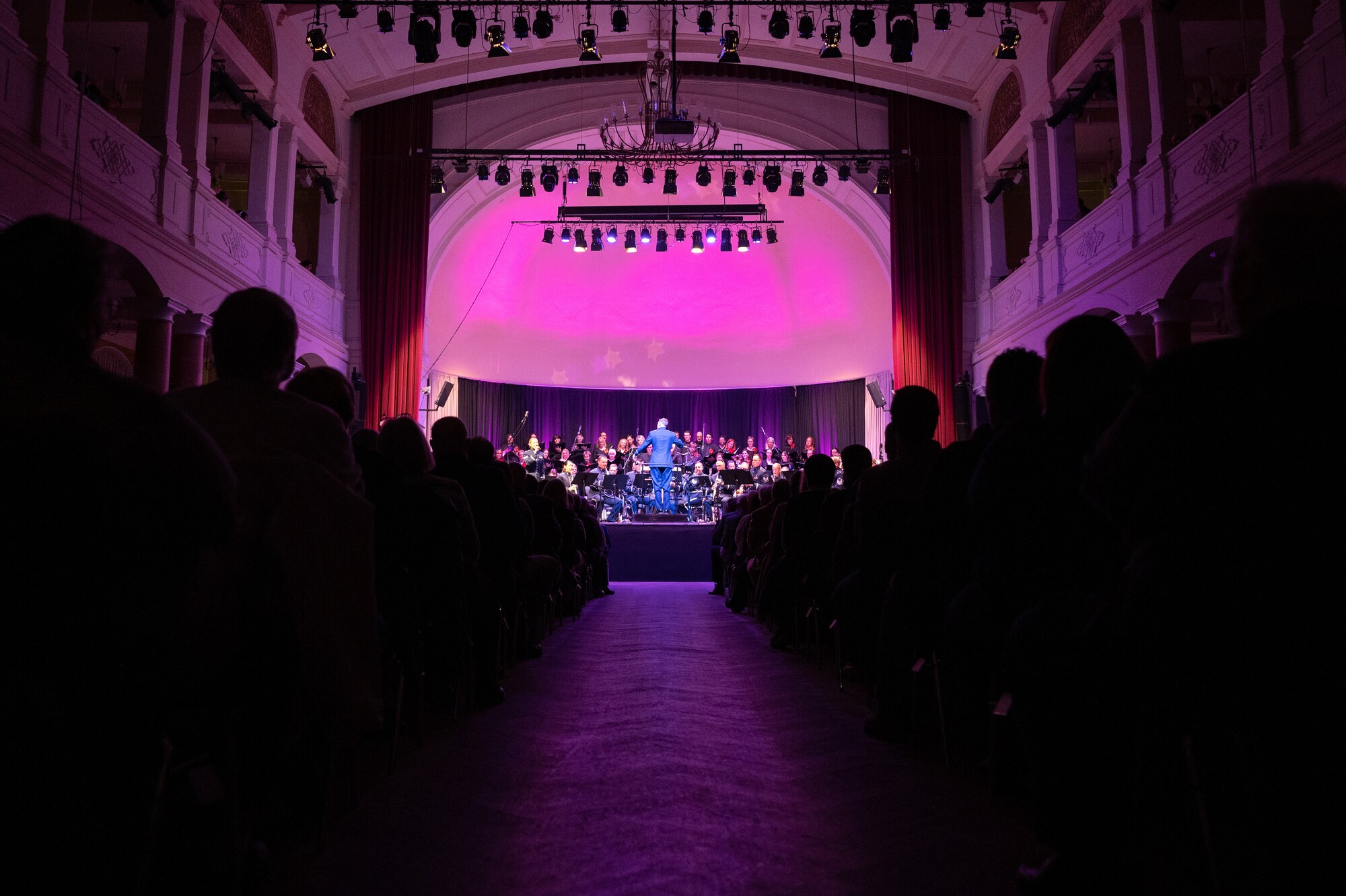 Local community members applaud the U.S. Air Forces in Europe - Air Forces Africa Band during the Kaiserslautern Military Community Christmas concert at the Fruchthalle in Kaiserslautern, Germany, Dec. 13, 2024.