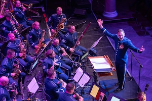 The U.S. Air Forces in Europe - Air Forces Africa Band and the Rheinland-Pfalz International Choir perform for an audience of military members and German nationals during the Kaiserslautern Military Community Christmas concert at the Fruchthalle in Kaiserslautern, Germany, Dec. 13, 2024.