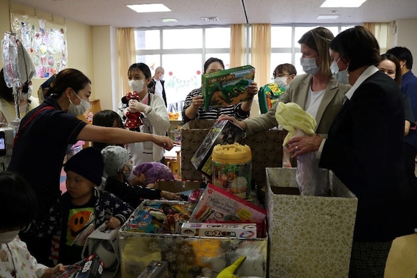 241217-N-DO281-1002 OKINAWA, Japan (Dec. 17, 2024) – Capt. Kathleen Cooperman, commanding officer, Navy Medicine Readiness and Training Command Okinawa, and Cmdr. Amy Aparicio hand out toys during a toy dive at Nambu Medical Center & Nambu Children’s Medical Center in Okinawa, Japan, Dec. 17, 2024. (U.S. Navy photo by Mass Communication Specialist 1st Class Trey Fowler)