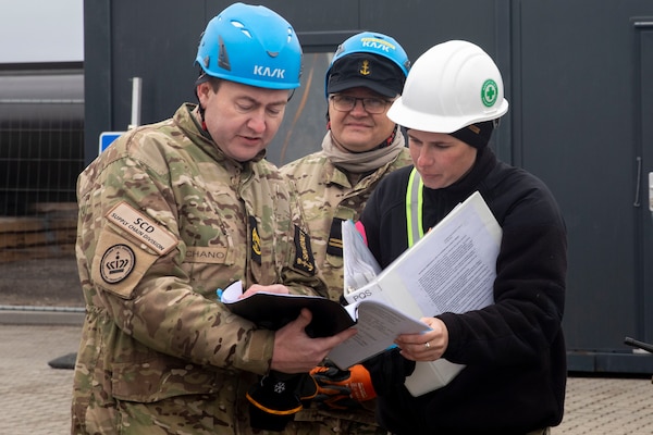 Sailors from NCHB-10 and members of the Royal Danish Navy transfer ammunition during the NATO-led maritime vigilance activity Neptune Strike.