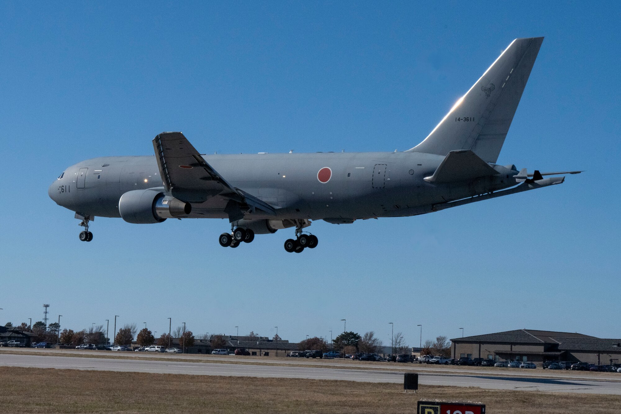 People group around to discuss operational capabilities relating to a KC-46 refueling airplane.