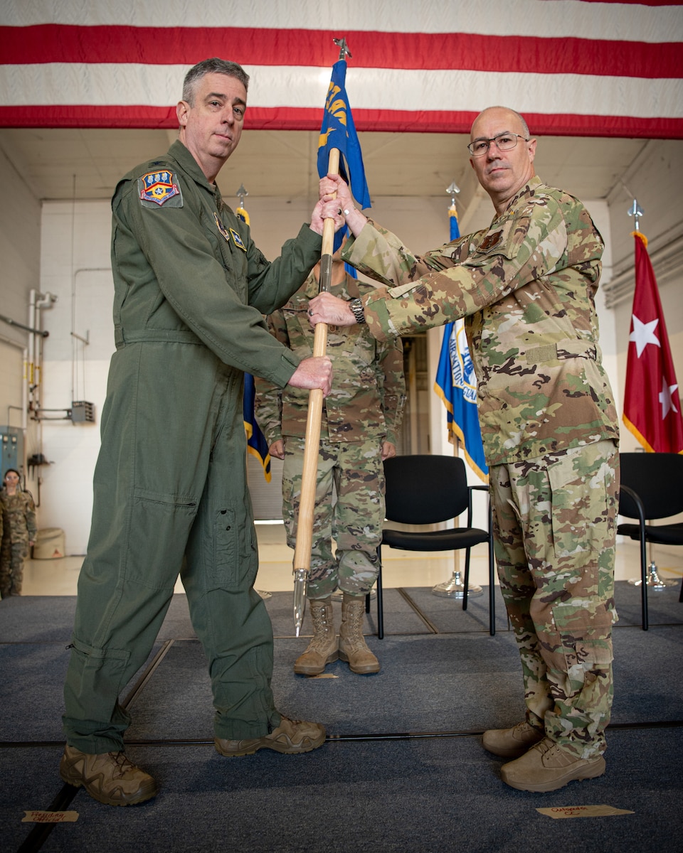 Col. Randall Hood, right, accepts the 123rd Operations Group guidon from Col. Bruce Bancroft, outgoing commander of the 123rd Airlift Wing, during a change-of-command ceremony at the Kentucky Air National Guard Base in Louisville, Ky., Oct. 11, 2024. Hood replaces Col. Matthew Quenichet, who has assumed command of the 123rd Airlift Wing. (U.S. Air National Guard photo by Master Sgt. Joshua Horton)