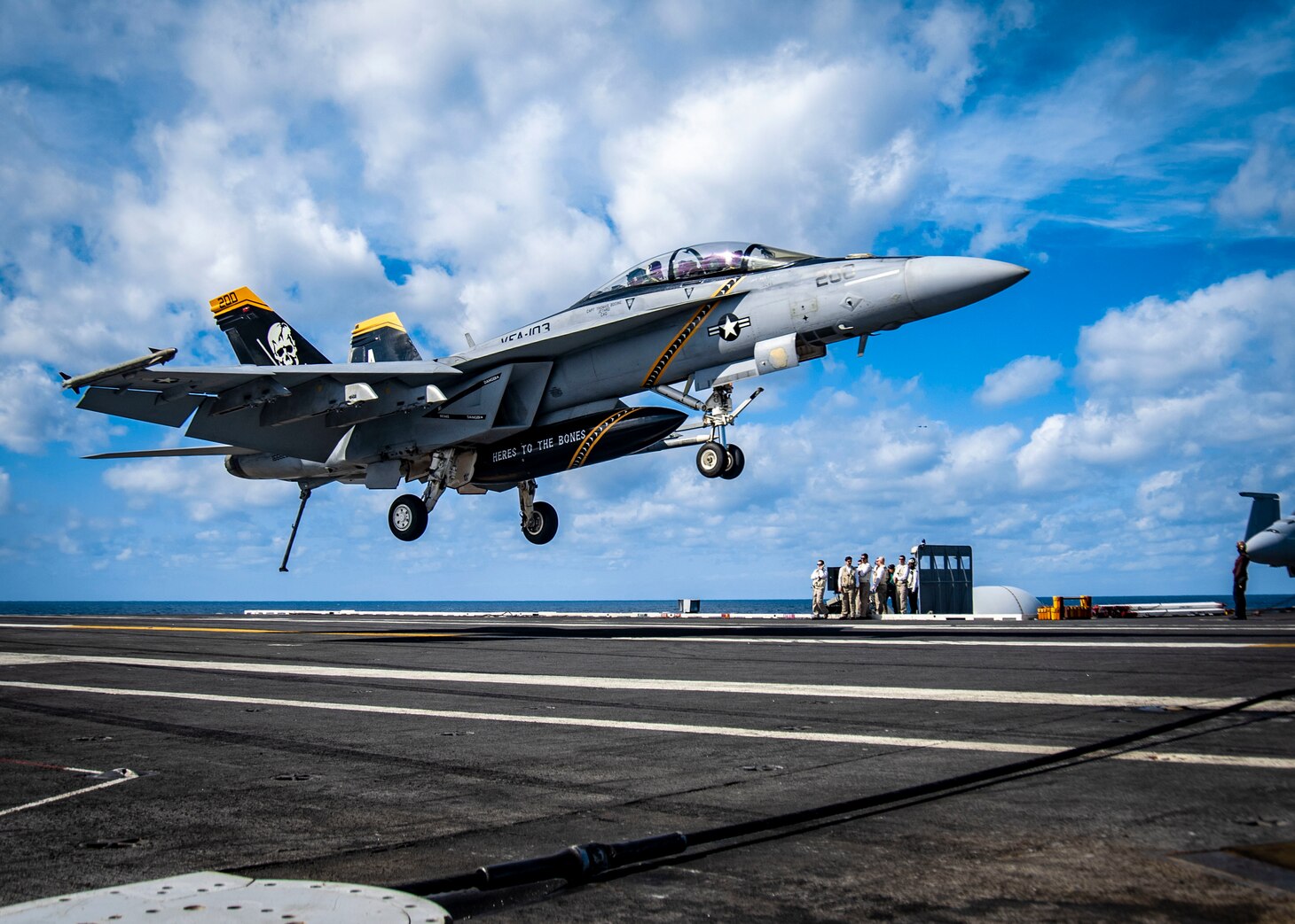 An F/A-18 F Super Hornet aircraft, assigned to Strike Fighter Squadron (VFA) 103, approaches the flight deck of the aircraft carrier USS George H.W. Bush (CVN 77). George H.W. Bush provides the national command authority flexible, tailorable war fighting capability through the carrier strike group that maintains maritime stability and security in order to ensure access, deter aggression and defend U.S., allied and partner interests.