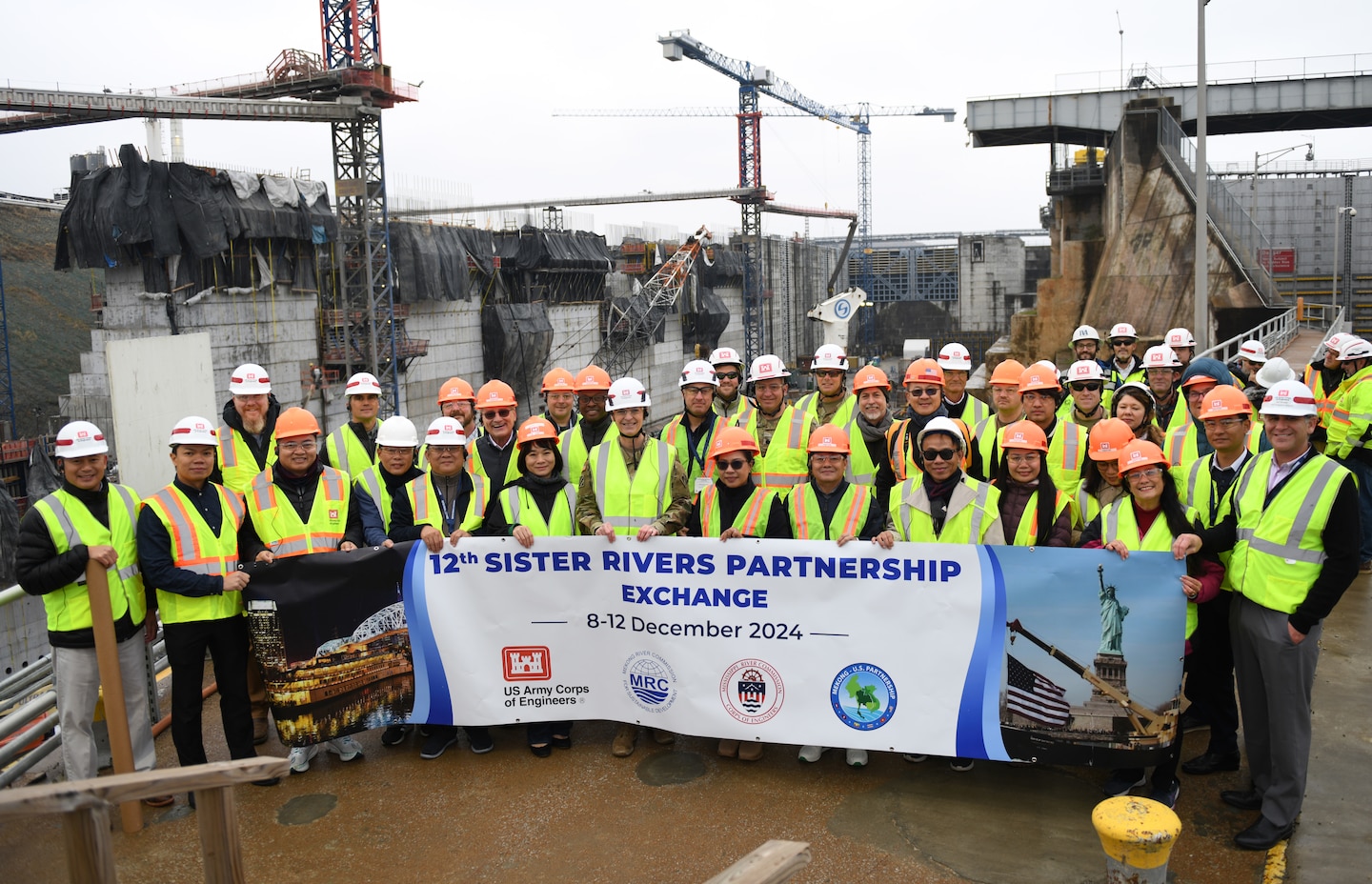 Participants of the 12th Mekong-Mississippi Sister Rivers Partnership Exchange pose together Dec. 10, 2024, at the Kentucky Lock Addition Project on the Tennessee River in Grand River, Kentucky. The Mekong River Commission and Mississippi River Commission met to strengthen international collaboration for sustainable management of water resources. Topics included management of population water resource needs, navigation, hydropower, environmental planning, flood risk management, and natural based solutions. The Sister Rivers Partnership Exchange supports the Mekong-U.S. Partnership (MUSP)