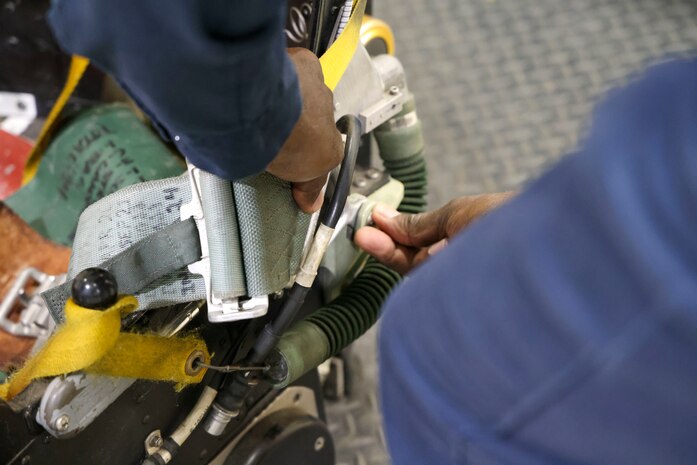 Charlie Toomer, 9th Maintenance Squadron egress systems craftsman, demonstrates use of a pin necessary to allow the egress systems on a pilots seat to function at Beale Air Force Base, Dec. 2, 2024.