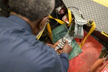 Charlie Toomer, 9th Maintenance Squadron egress systems craftsman, demonstrates how the buckle is properly prepared after working on the egress systems of a pilots seat at Beale Air Force Base, Dec. 2, 2024.