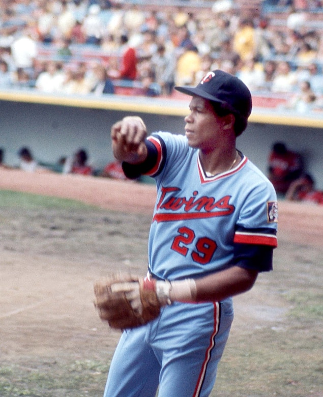 A baseball player is pictured after throwing a baseball.