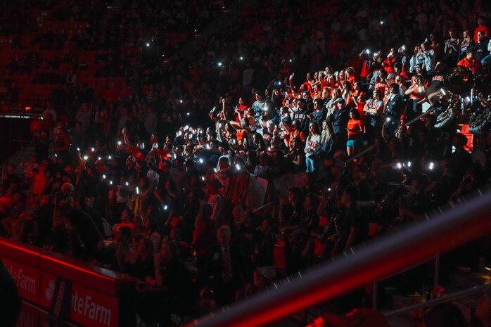 Guests of the San Diego State University Men's Basketball game cheer the team on during the game in San Diego, California, Dec. 11, 2024. U.S. Marine Corps Sgt. Dennis Maina, assistant for Officer Selection Team San Diego, Recruiting Station San Diego, was recognized as the guest of honor during the game. The guest of honor received special recognition including a formal introduction, reserved seating and participation in game-day activities. (U.S. Marine Corps photo by Cpl. Alejandro Fernandez)