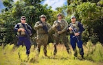 The U.S. Coast Guard team, comprised of members from the Forces Micronesia Sector Guam Sector Boarding Team and Port Security Unit 311, stands for a photo prior to the Battle of the Branches joint competitive marksmanship challenge at Andersen Air Force Base on Nov. 22, 2024. The inaugural event saw seven teams from multiple branches and the Guam Police Department shoot at nine stations testing their skills, building relationships, and sharpening collective readiness. (U.S. Coast Guard photo by Chief Warrant Officer Sara Muir)