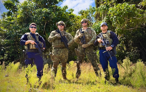 The U.S. Coast Guard team, comprised of members from the Forces Micronesia Sector Guam Sector Boarding Team and Port Security Unit 311, stands for a photo prior to the Battle of the Branches joint competitive marksmanship challenge at Andersen Air Force Base on Nov. 22, 2024. The inaugural event saw seven teams from multiple branches and the Guam Police Department shoot at nine stations testing their skills, building relationships, and sharpening collective readiness. (U.S. Coast Guard photo by Chief Warrant Officer Sara Muir)