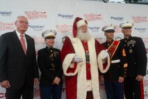 Retired and active duty U.S. Marines walk the red carpet with Santa Clause during the 92nd Hollywood Christmas Parade in Hollywood, California, Dec. 1, 2024. The mission of the Toys for Tots Holiday Program is to collect new, unwrapped toys, books, and other gifts and distribute them to less fortunate children at Christmastime. The Hollywood Christmas Parade is an annual American parade held on the Sunday after Thanksgiving in Hollywood; it follows a 3.5-mile route along Hollywood Boulevard, then back along Sunset Boulevard, featuring various celebrities. (U.S. Marine Corps photo by Cpl. Fred Garcia)