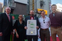 Retired U.S. Marine Corps Maj. Gunnar Spafford, deputy vice president of business development with Toys for Tots, holds a certificate of commendation for the city of Los Angeles prior to the start of the 92nd Hollywood Christmas Parade in Hollywood, California, Dec. 1, 2024. The mission of the Toys for Tots Holiday Program is to collect new, unwrapped toys, books, and other gifts and distribute them to less fortunate children at Christmastime. The Hollywood Christmas Parade is an annual American parade held on the Sunday after Thanksgiving in Hollywood; it follows a 3.5-mile route along Hollywood Boulevard, then back along Sunset Boulevard, featuring various celebrities. (U.S. Marine Corps photo by Cpl. Fred Garcia)