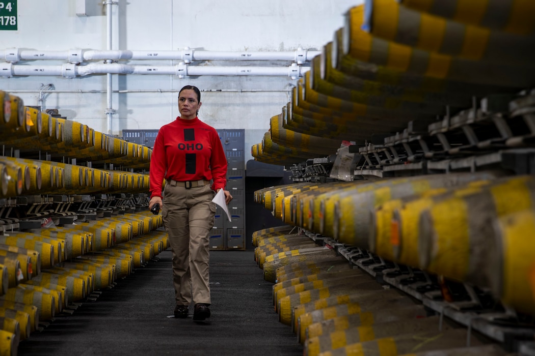 Lt. Cmdr. Maria Relayo inspects ammunition before transportation aboard USS Abraham Lincoln (CVN 72) during an ammunition transfer.