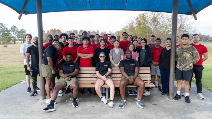 U.S. Marines, poolees, and guests with Recruiting Sub Station Beaumont, Recruiting Station Houston, pose for a photo after an initial strength test at Gulf Terrace Park in Beaumont, Texas, Dec. 14, 2024. The poolees were evaluated on their pull-ups, ammo can lifts, plank, and 1.5-mile run in order to prepare them for recruit training. (U.S. Marine Corps photo by Sgt. Ryan H. Pulliam)