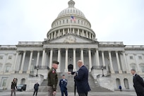 A soldier and civilian discuss plans for the pass in review outside of the U.S. Capitol