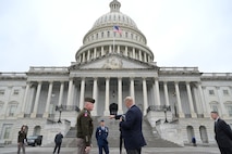 A soldier and civilian discuss plans for the pass in review outside of the U.S. Capitol