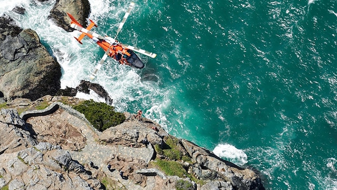 An MH-65 crew conducts vertical surface training off the coast of Humboldt Bay, California, to hone critical skills to ensure precise and efficient hoisting techniques in this rugged, coastal environment.